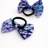 Kids bow hair tie with a lavender bow made from soft lycra fabric