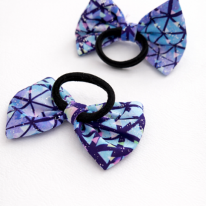 Kids bow hair tie with a lavender bow made from soft lycra fabric