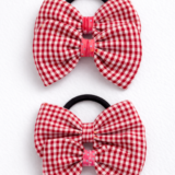 Kids bow hair tie with a red gingham cotton bow attached to a hair elastic